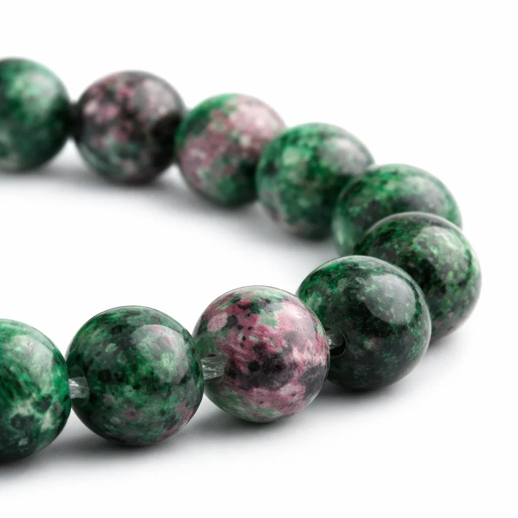Natural ruby zoisite crystal bracelet with round beads on a clean white background