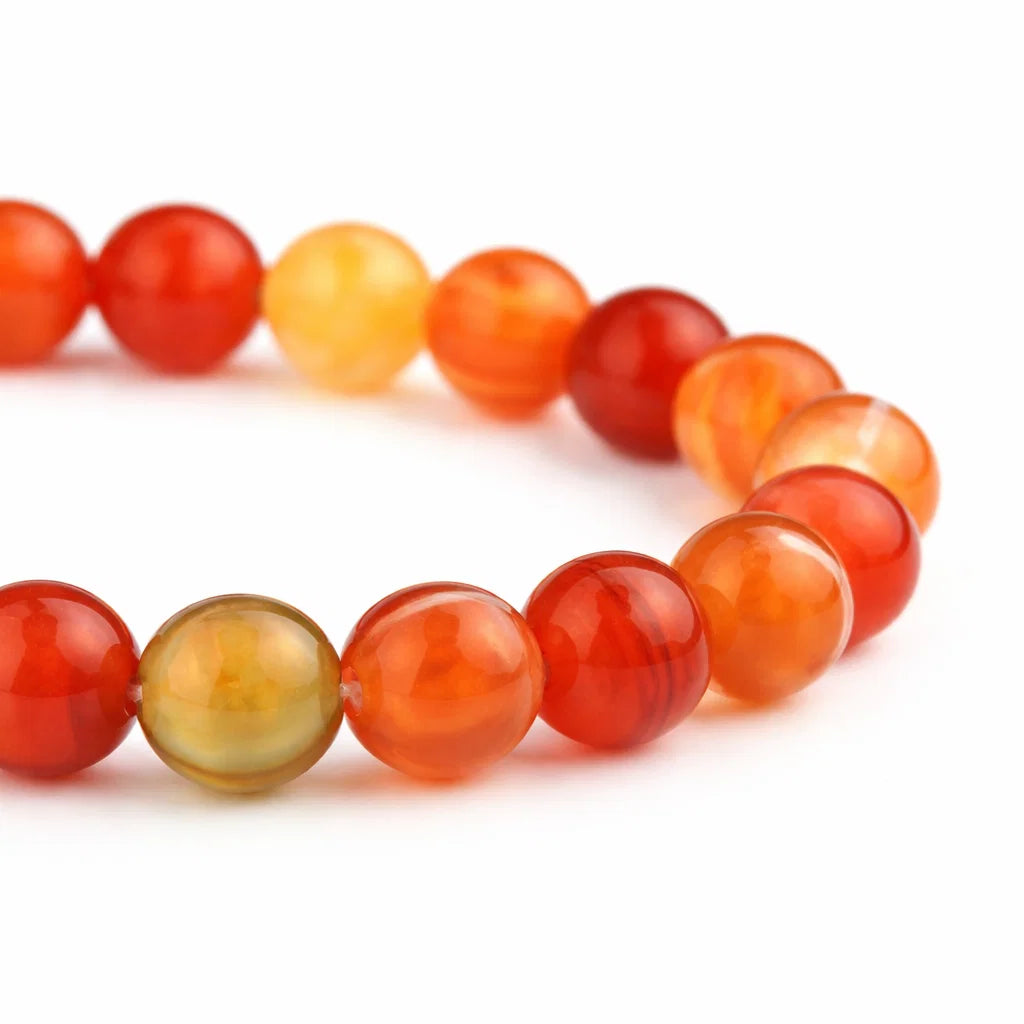 Natural red agate crystal bracelet with round beads on a clean white background