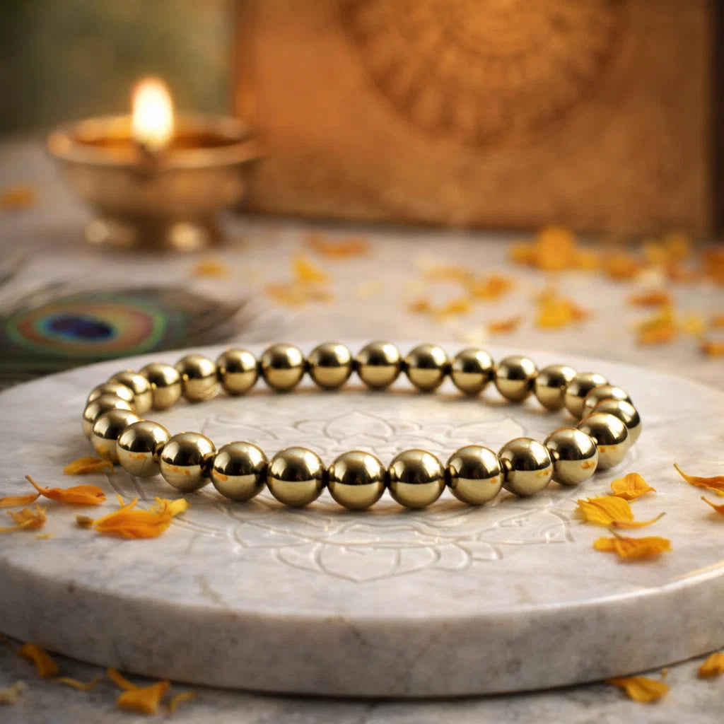 Golden pyrite bead bracelet, Vastu remedy presented with a hand for visual scale