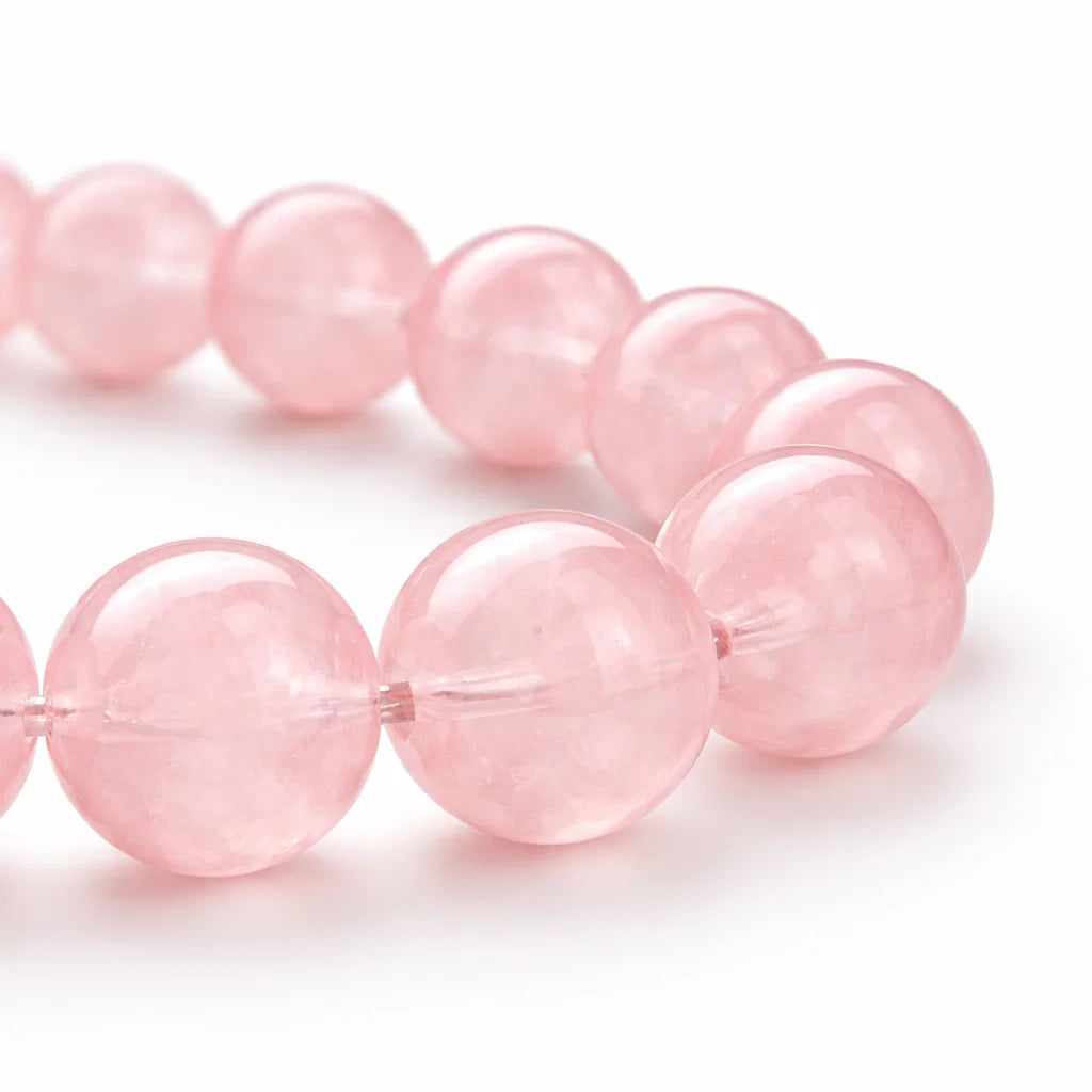 Natural rose quartz crystal bracelet presented with a hand for visual scale