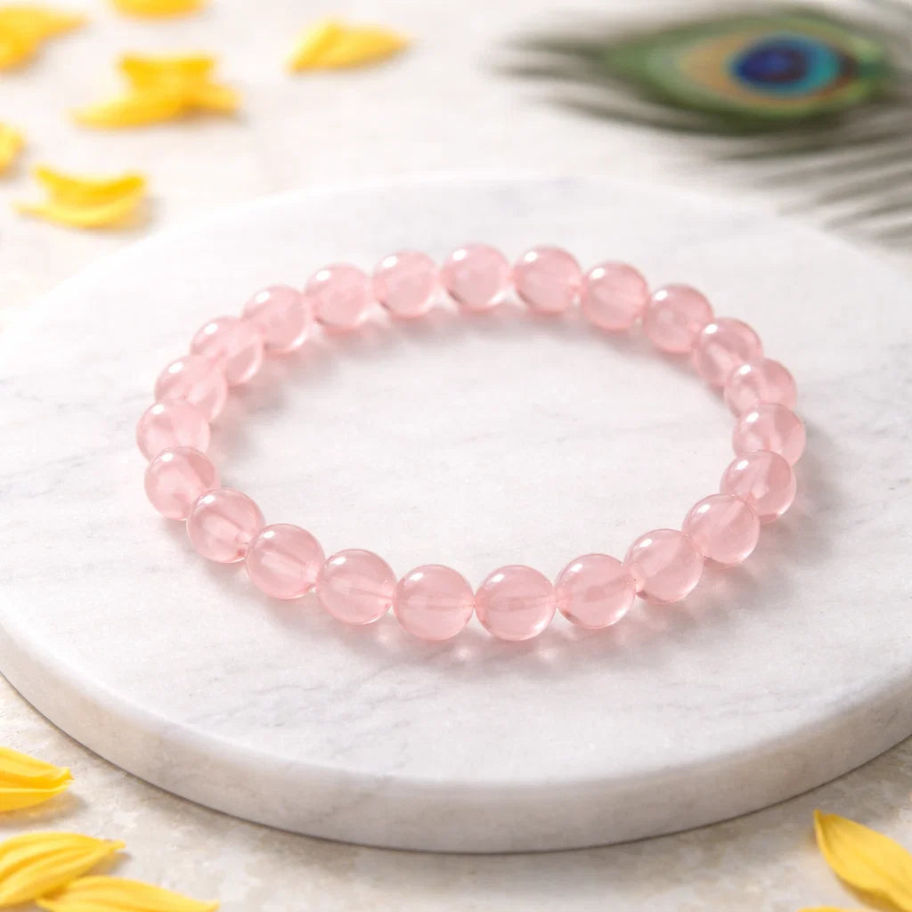 Natural rose quartz crystal bracelet shown with a hand in a lifestyle photograph