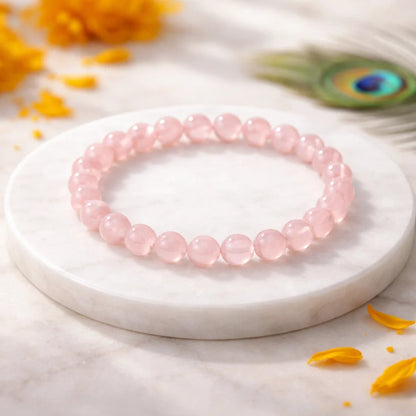 Natural rose quartz crystal bracelet shown in a second hand-held product view