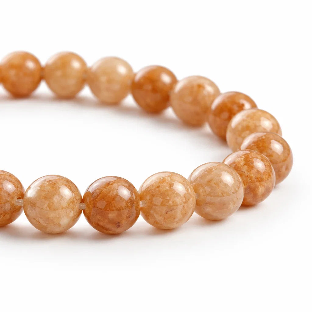 Natural sunstone crystal bracelet presented with a hand for visual scale