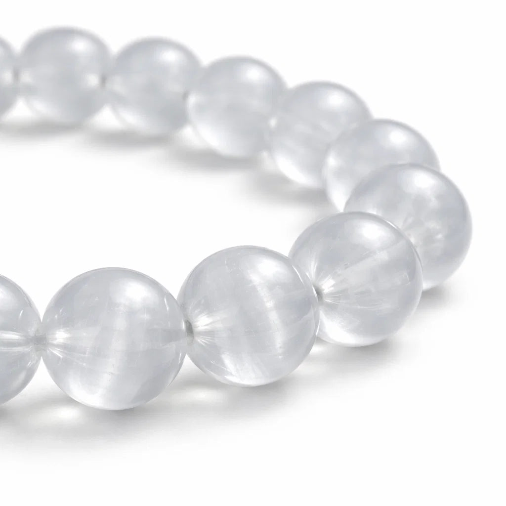 Natural selenite crystal bracelet with round beads on a clean white background