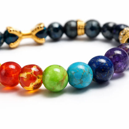 7 chakra destiny claw bracelet with round beads on a clean white background
