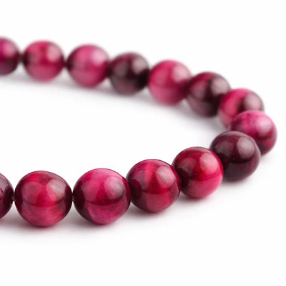 Natural pink tiger eye crystal bracelet in a close white-background bead view