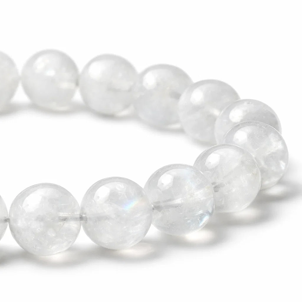 Natural rainbow moonstone crystal bracelet showing the bead colour and surface on white