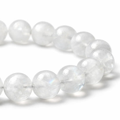 Natural rainbow moonstone crystal bracelet showing the bead colour and surface on white