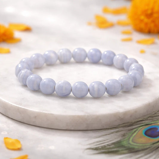 Blue lace agate crystal bracelet shown with a hand in a lifestyle photograph