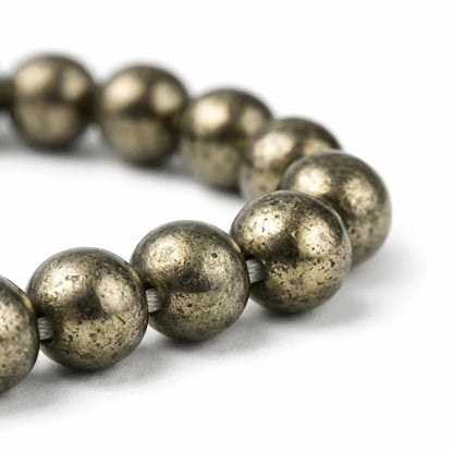 Close-up of metallic pyrite mala beads showing their speckled gold-grey finish
