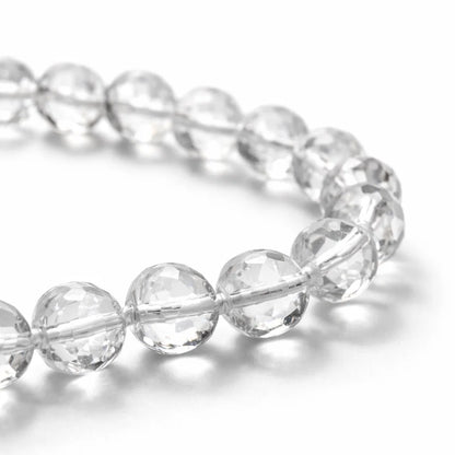 Close-up of clear sphatik mala beads showing faceted surfaces and string knots