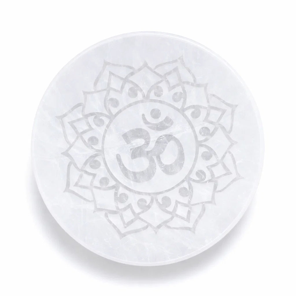 Om symbol selenite plate showing its form against a plain white background