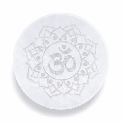 Om symbol selenite plate showing its form against a plain white background