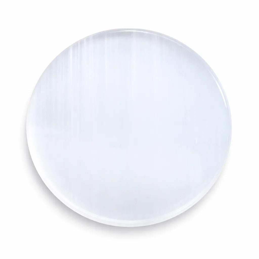 Plain round selenite plate in a close product view on white