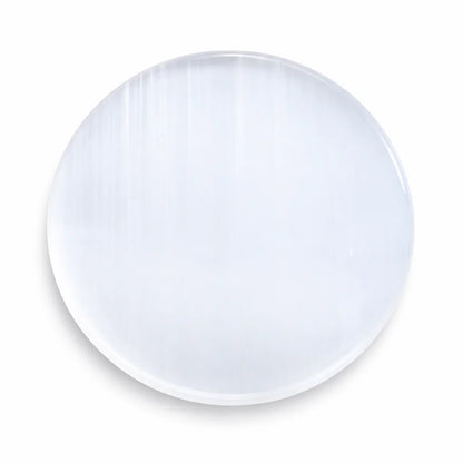 Plain round selenite plate in a close product view on white