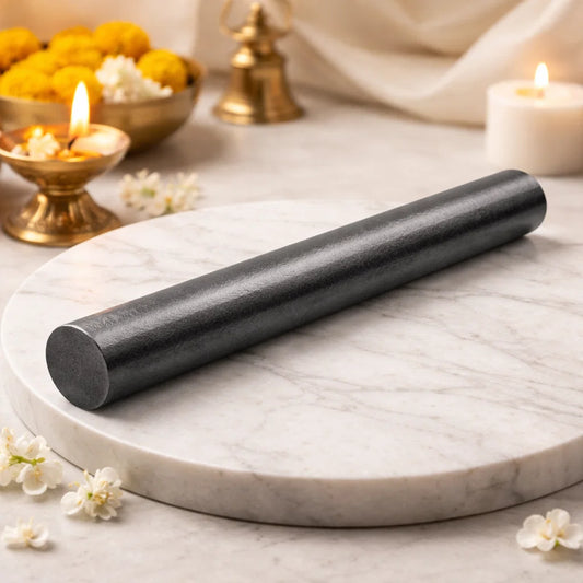 Iron Vastu virtual rod displayed on a white marble pedestal with flowers and diya