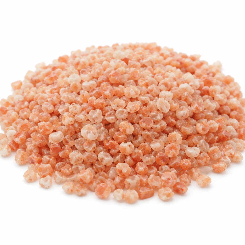 Close-up of small raw sunstone chips on white showing natural colour variation