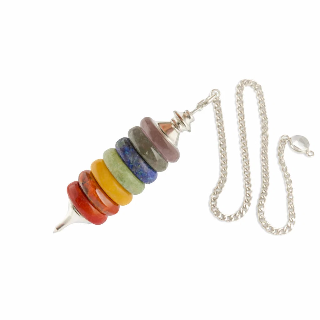 Seven chakra pendulum and full silver chain arranged diagonally on a white background