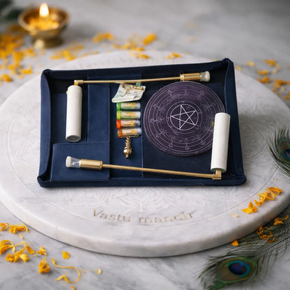 Open black leather dowsing case displayed on a white marble plate with complete tools