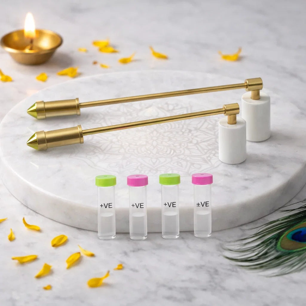 Brass dowsing rods with white PVC handles and labelled sample vials in a sacred setting