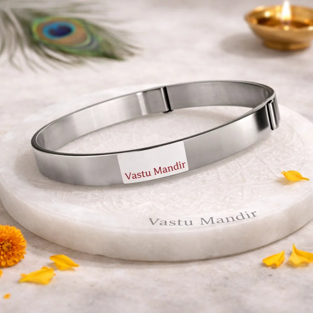 Iron Vastu strip coil on a round plate with petals and a blurred diya