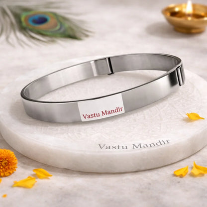 Iron Vastu strip coil on a round plate with petals and a blurred diya