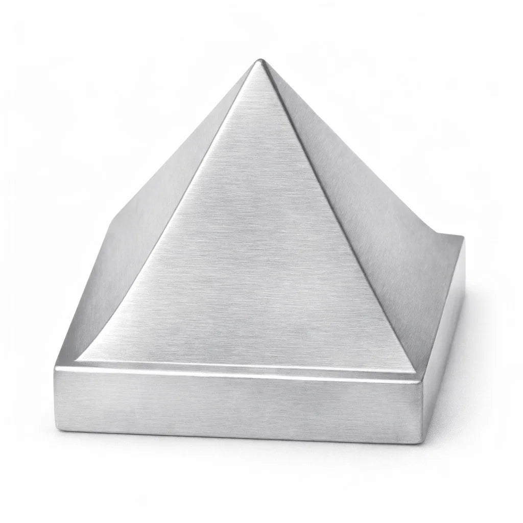 Solid aluminium Vastu pyramid isolated in angled view on white background