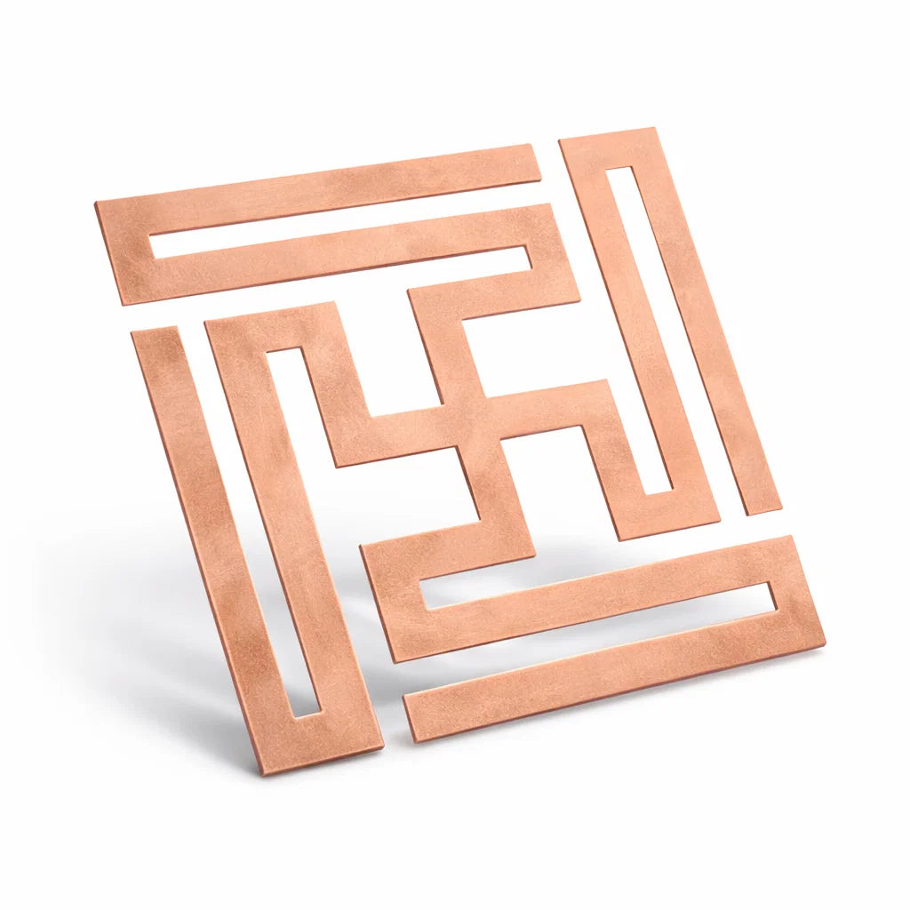 Copper nandavrat Swastik yantra in a close product view on white