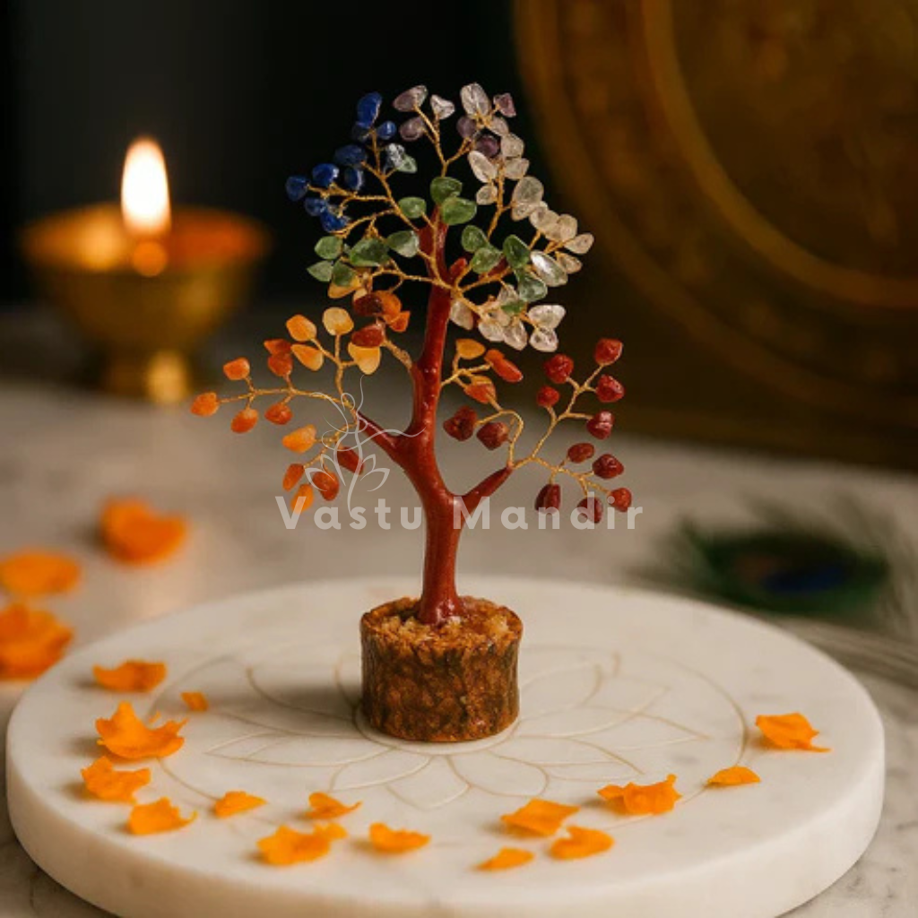 Seven chakra crystal tree displayed in a dark, softly lit spiritual setting