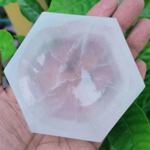 Hexagon selenite charging bowl displayed in a softly lit product setting