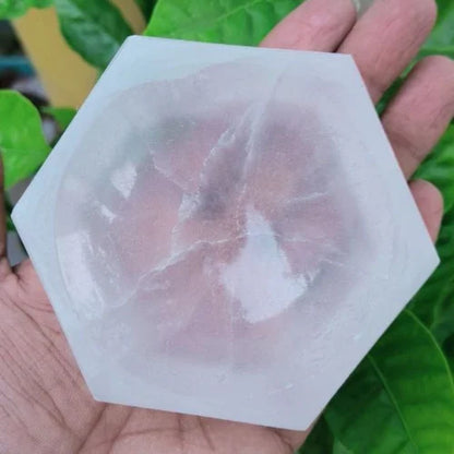 Hexagon selenite charging bowl displayed in a softly lit product setting